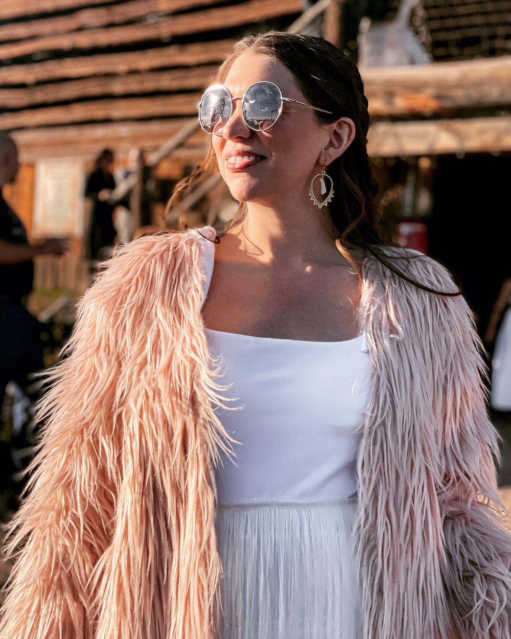 Woman in pink furry coat and sunglasses